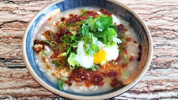 savory oatmeal in the style of congee, mushroom stock, chili oil, scallions, cilantro, 63 degree 