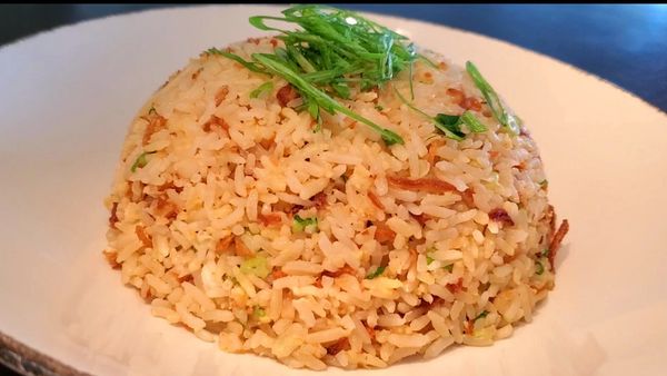 Egg fried rice, made with freshly cooked rice, garlic, fried shallots and scallions.