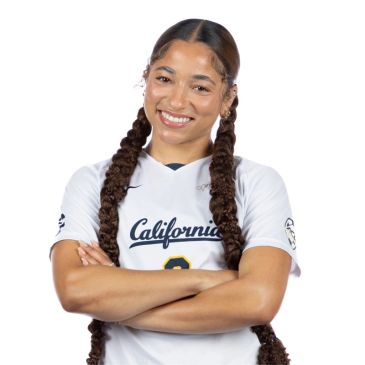 Smiling athlete in California jersey with long braided hair.