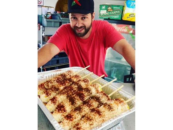 owner of johnny lote presenting elote 