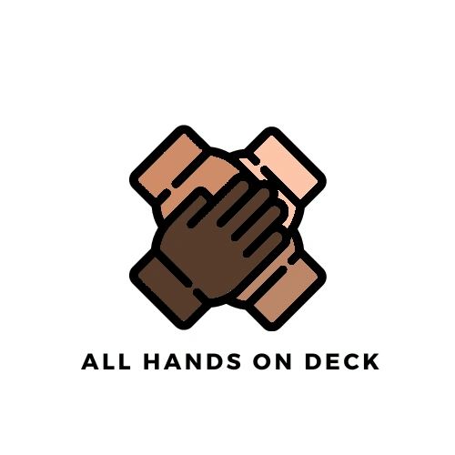 Four hands of different skin tones stacked together symbolizing unity.