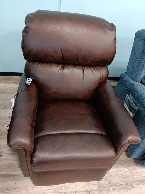 A brown leather recliner chair with a remote control on the armrest.