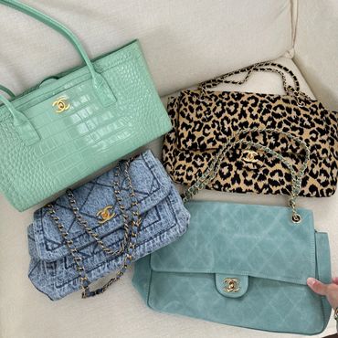 Four Chanel handbags with different designs and colors.