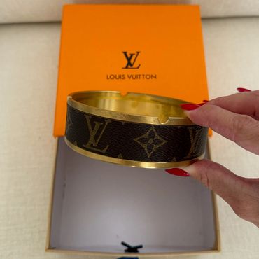 Louis Vuitton ashtray with iconic monogram design.