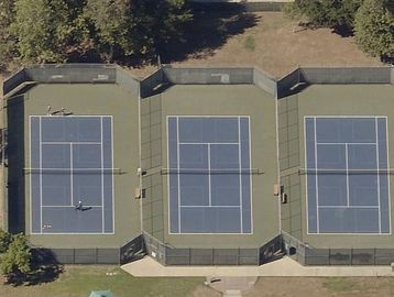 Aerial view of three adjacent tennis courts.