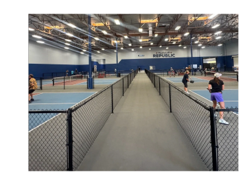 Indoor pickleball courts with players.