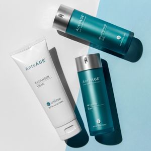 AnteAGE Skincare Cleanser in a white bottle and AnteAGE Skincare Serum and Accelerator in turquoise pump bottles.