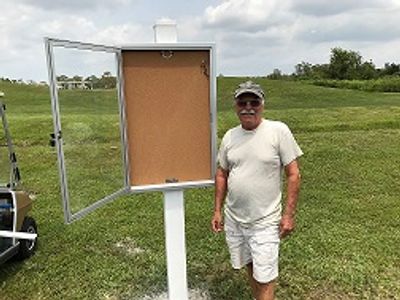 Bob Frechette standing at Bulletin Board