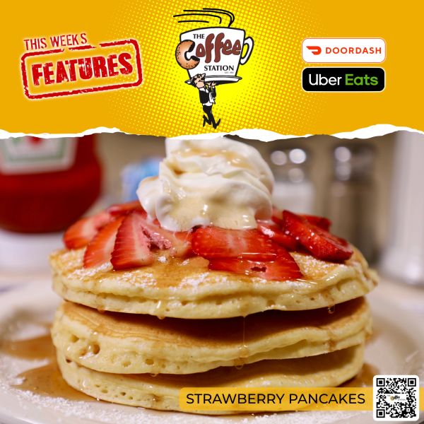 Stack of strawberry pancakes topped with whipped cream and syrup.