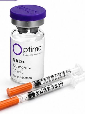 Vial of NAD+ solution with two syringes on a white surface.