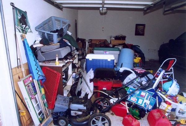 Photo of a pile of junk inside a garage.