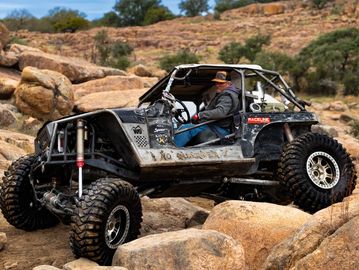 Off-road vehicle navigating rocky terrain.