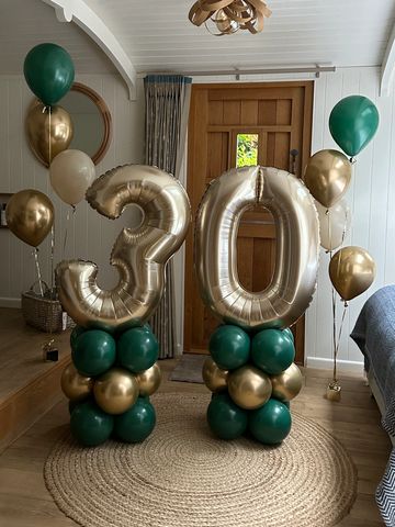 Gold and green balloons celebrating a 30th birthday.