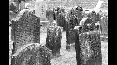 An ancient graveyard in the early morning.