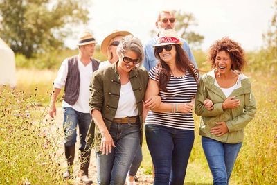 Group of friends enjoying a sunny outdoor walk together.