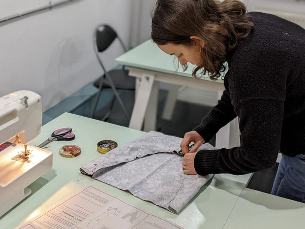 woman pinning fabric together during a sewing lesson