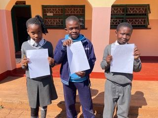 3 children holding letters