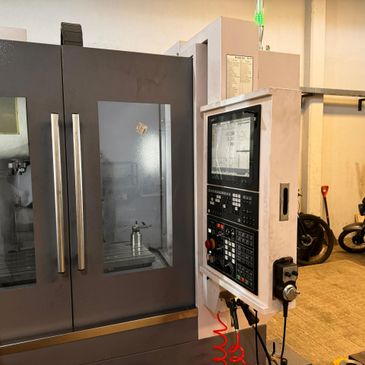 CNC machine with control panel in an industrial workshop.