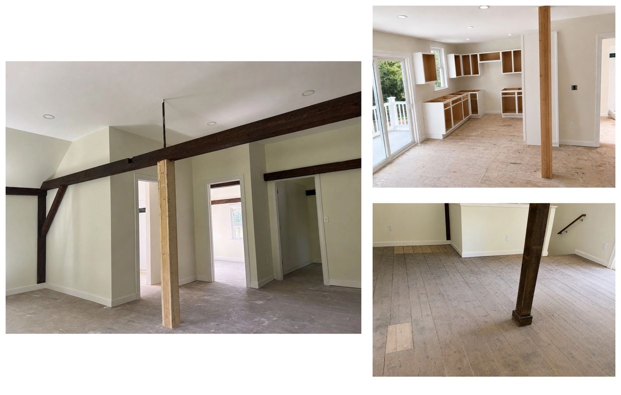 Renovated interior with exposed wooden beams and unfinished floors.