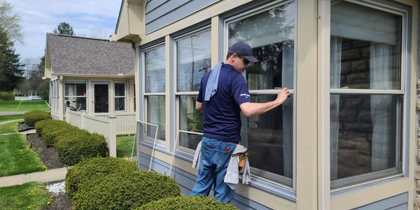 Washing a window.