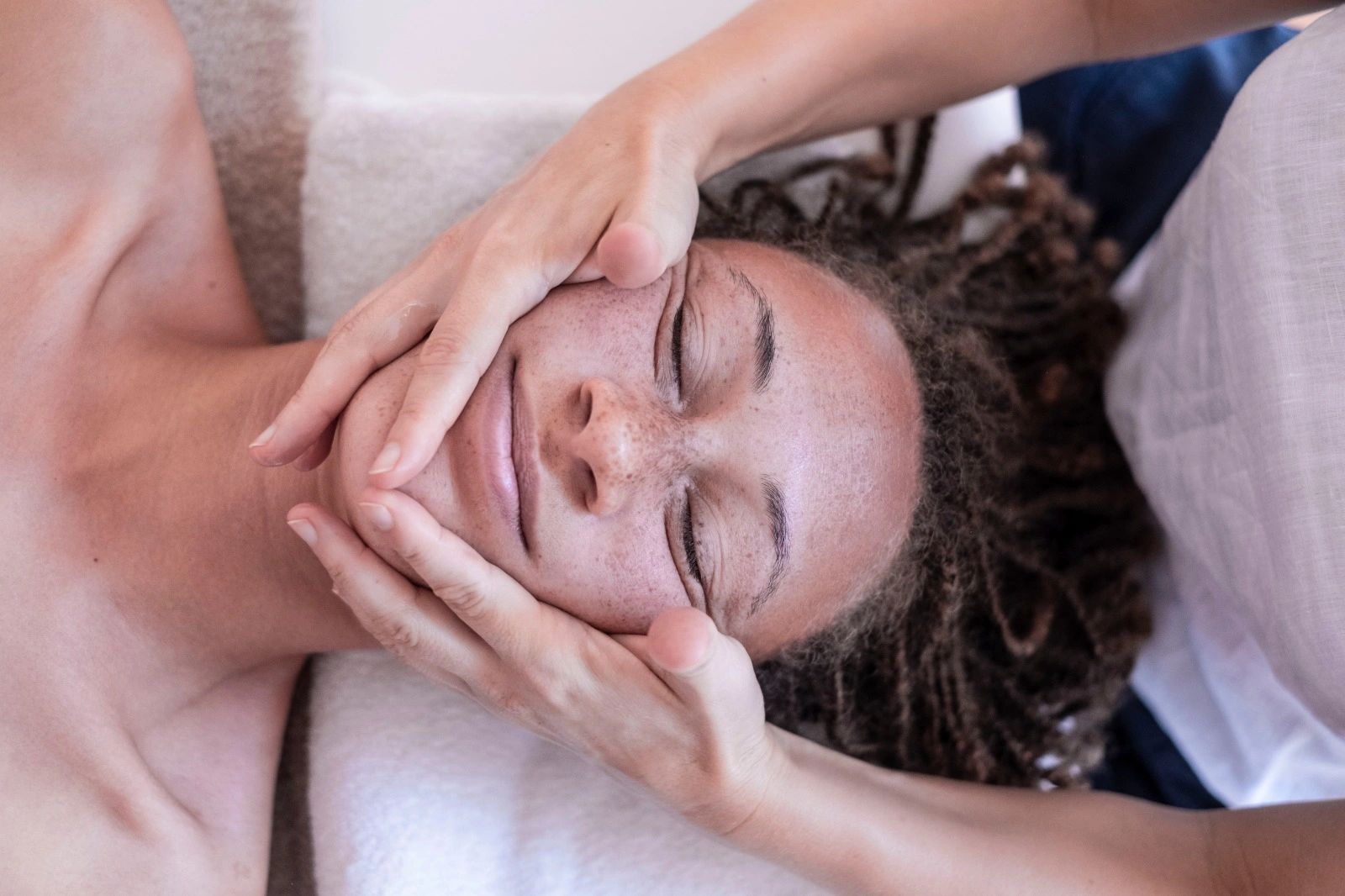 A woman is having a facial with ethical vegan skincare products in massage studio in Lagos Portugal
