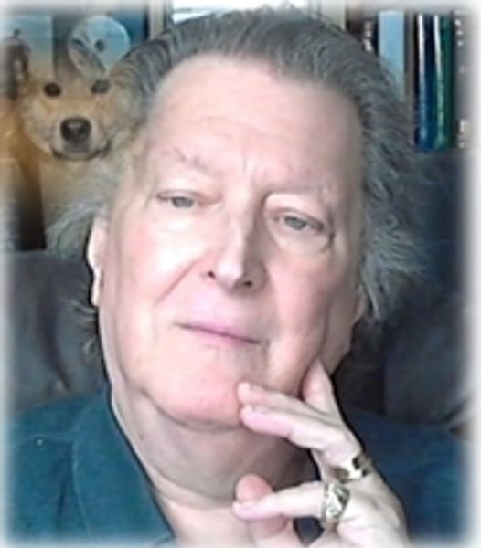 A thoughtful pose by medieval murder mysteries Author Dr. Peter Stephenson with rings poses indoors, a dog photo in the background.