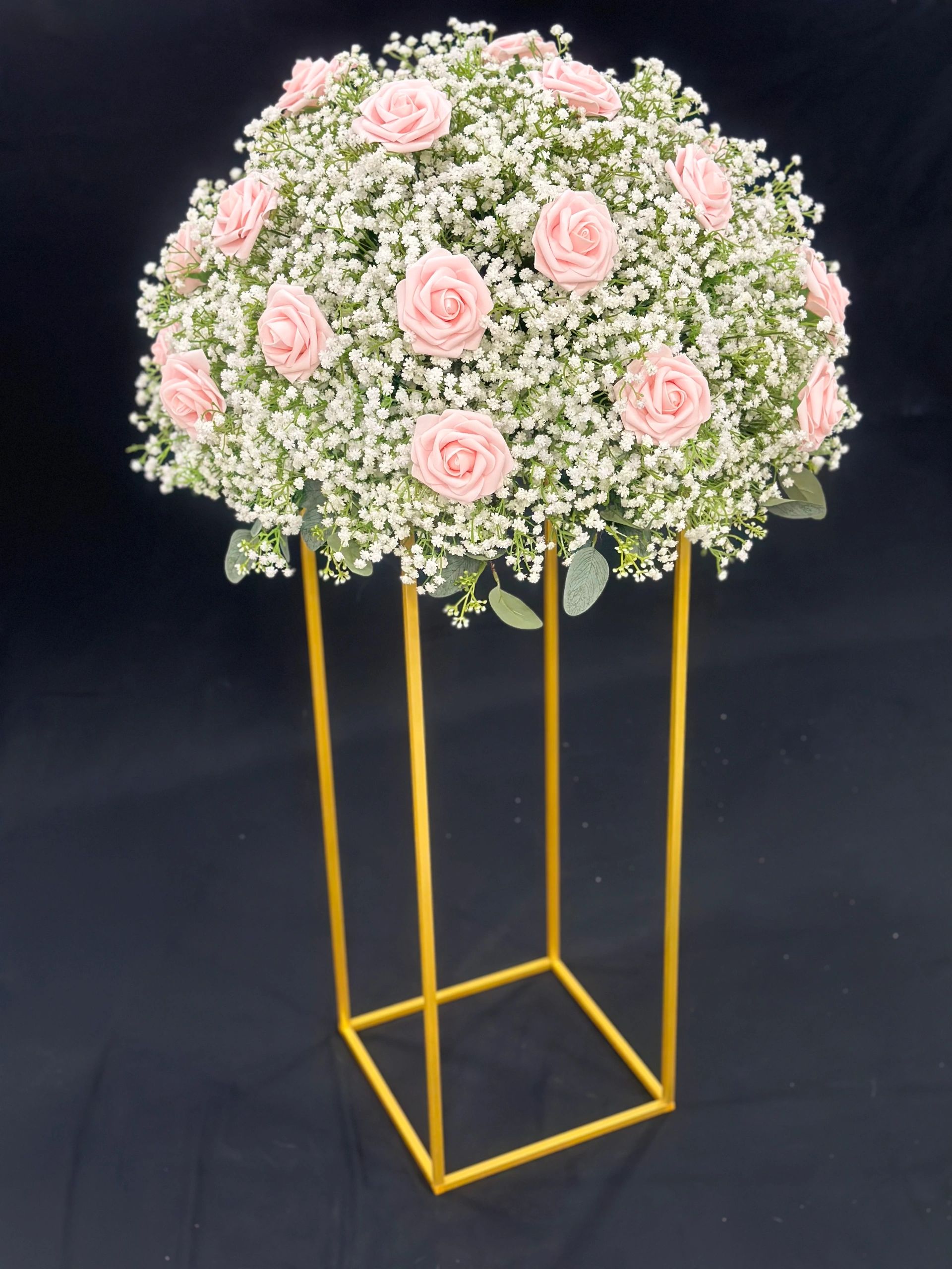 Roses in your choice of color surrounded by a large spray of Babies Breath on a brushed gold stand.