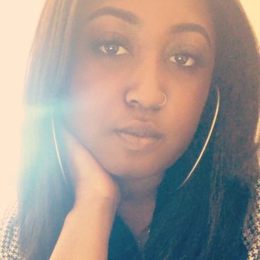 Close-up portrait of a woman with hoop earrings.