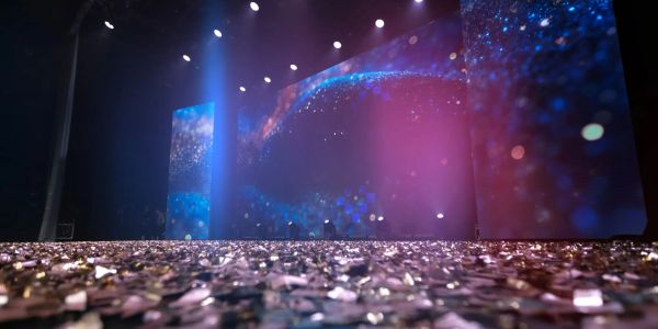 Stage with sparkling confetti and colorful lights.