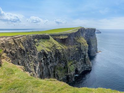 cliffs of Moher green fields cliffs and water  