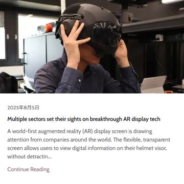 Person wearing an advanced AR helmet in a tech lab setting.