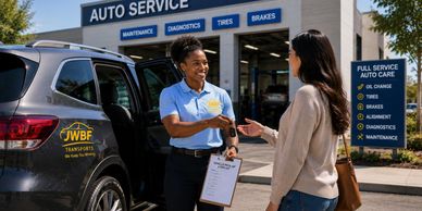 Auto service employee shaking hands with a customer outside a repair shop.
