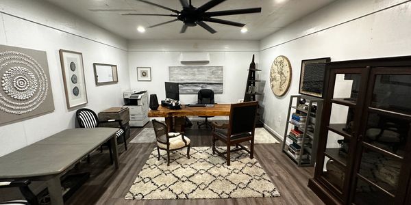Modern office with artistic decor and wooden furniture.