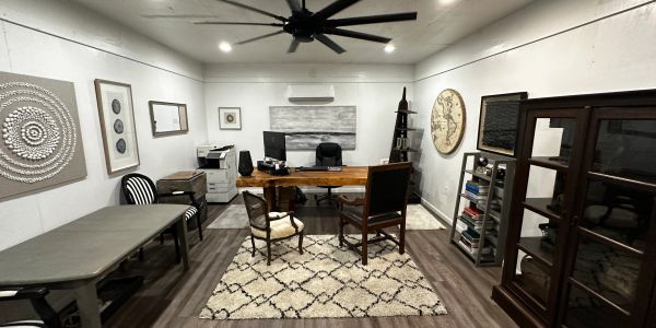 Modern office with artistic decor and wooden furniture.