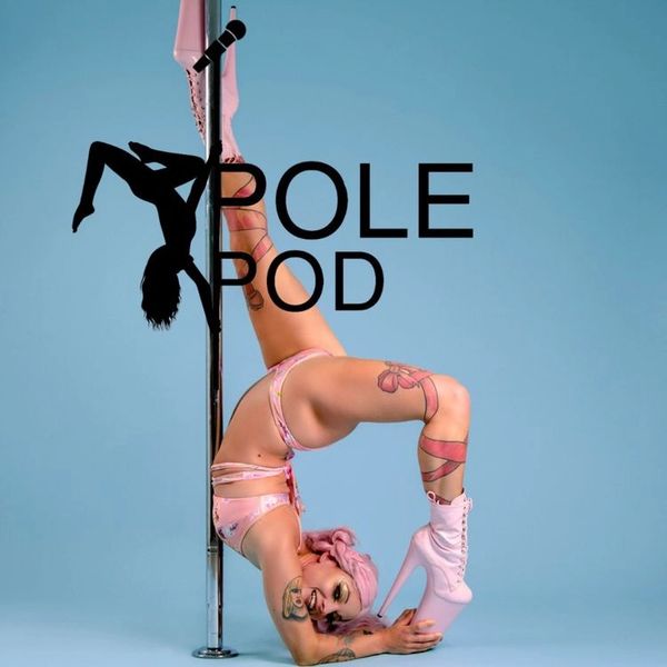 A woman in pink performs a flexible pole dance pose against a blue backdrop.