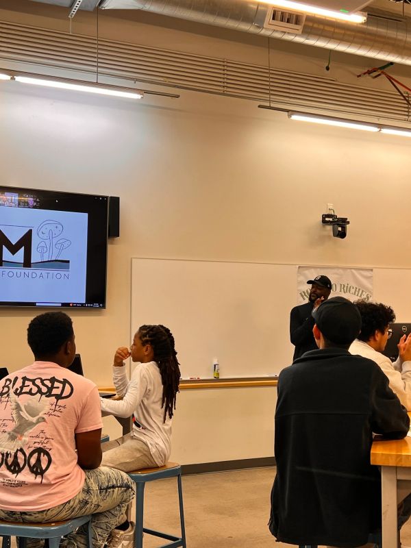 People attend a presentation on the BAM Mushroom Foundation in a classroom.