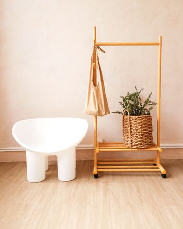 Clothes rack and rattan basket with aesthetic chair.