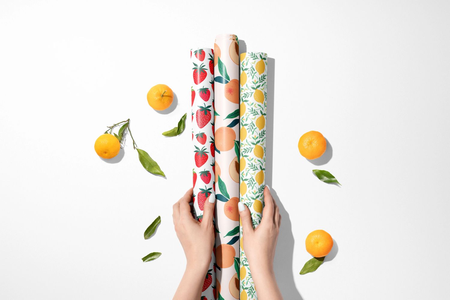 Wrapli luxury wrapping paper rolls with colourful botanical designs, oranges and leaves
