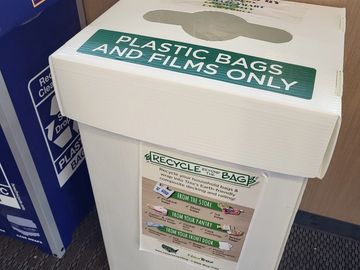 Recycling bin labeled for plastic bags and films only.