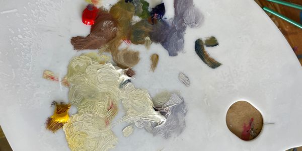 Close up of Chris Dickinson's palette with mixed oil paints