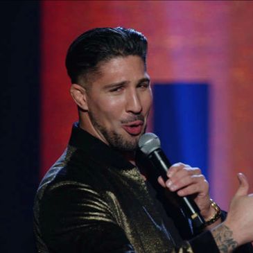 Brendan Schaub telling jokes to crowd of laughing civilians.