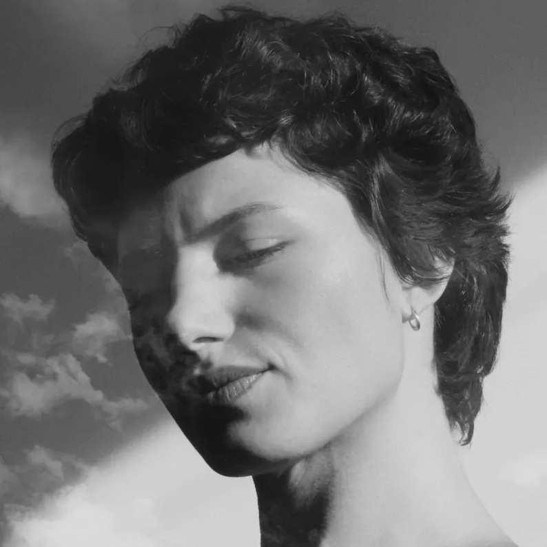 Black and white portrait of a person with eyes closed.