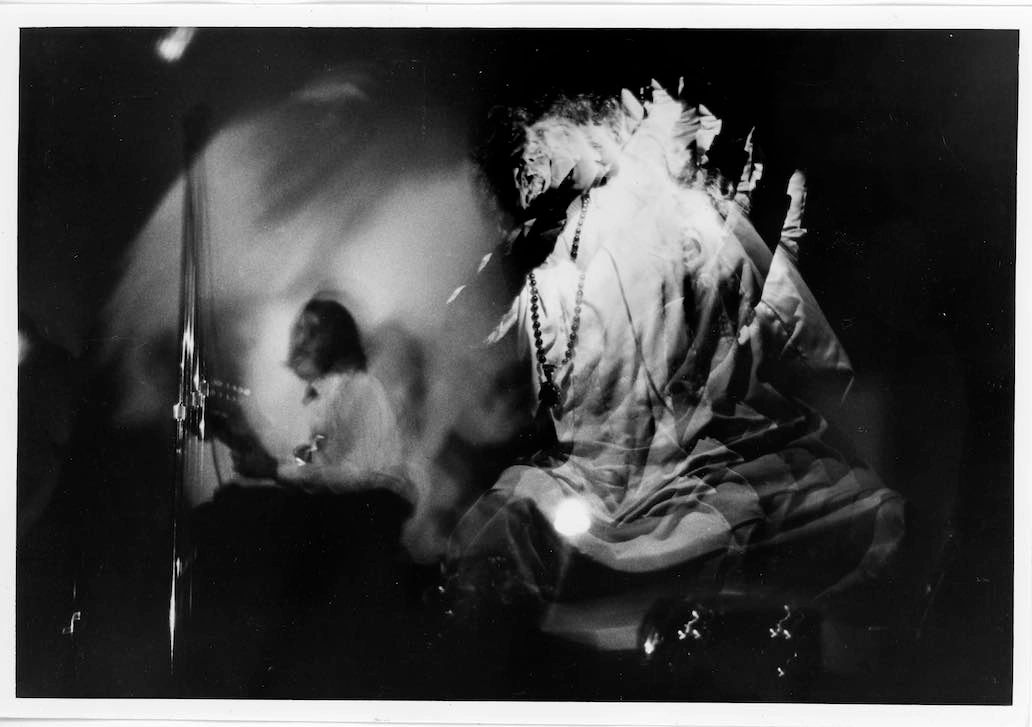 Gerard Malanga performing his strobe dance for the Exploding Plastic Inevitable (with John Cale in background) at the Balloon Farm (NYC), 1966. Photo by Diane Dorr-Doryneck/Courtesy of Gerard Malanga Personal Collection. Gerard Malanga performing his strobe dance for the Exploding Plastic Inevitable (with John Cale in background) at the Balloon Farm (NYC), 1966. Photo by Diane Dorr-Doryneck/Courtesy of Gerard Malanga Personal Collection.