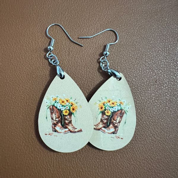 Teardrop earrings with cowboy boots and sunflower design.