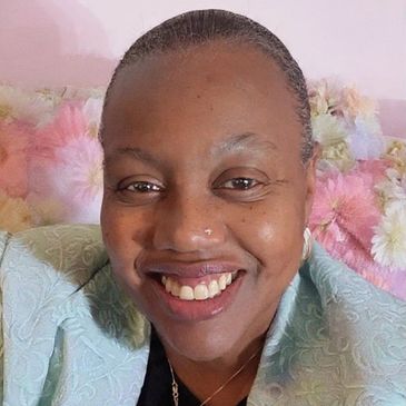 Woman smiling warmly for a close-up photo.