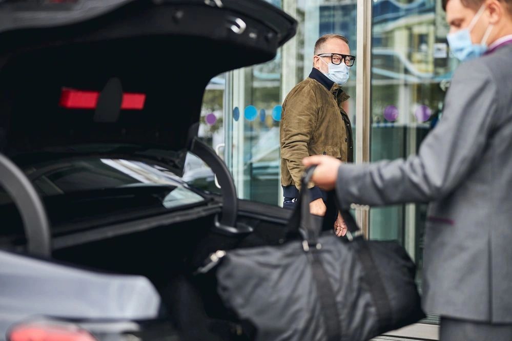 Driver helping client with luggage