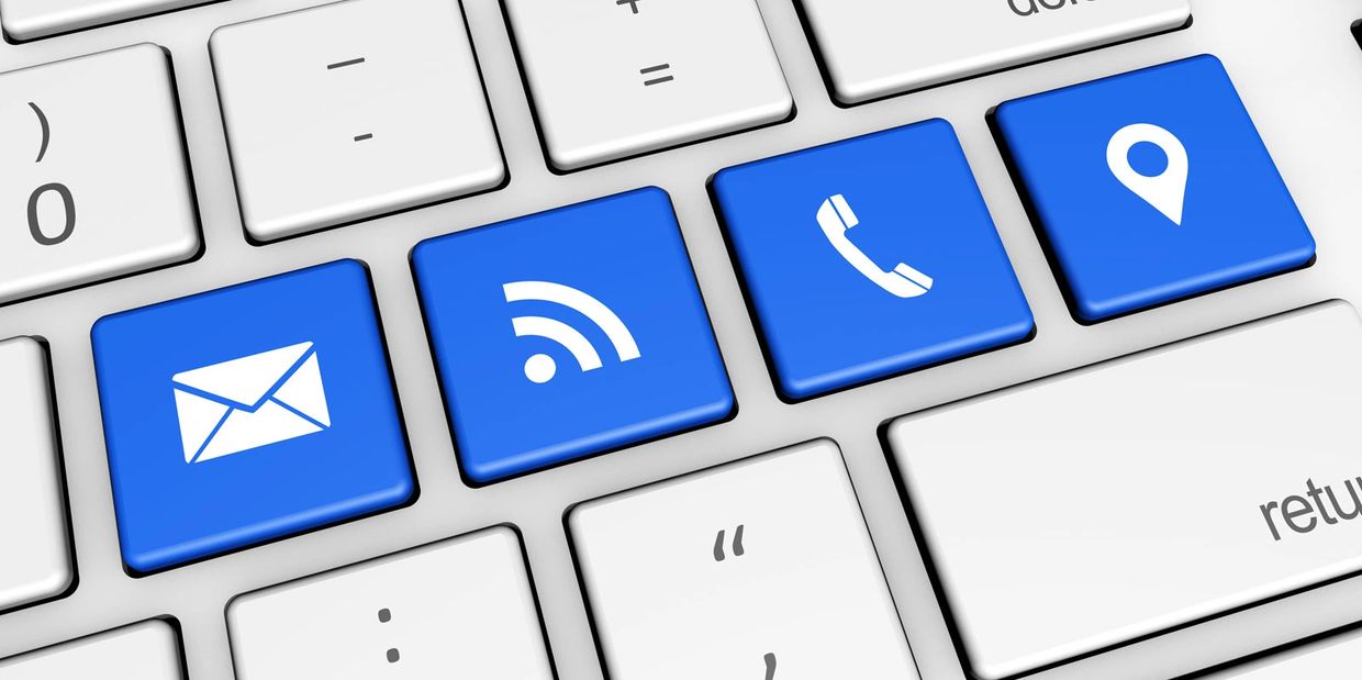 Blue contact icons on computer keyboard