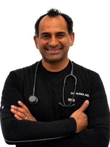 Smiling male doctor with stethoscope and crossed arms.