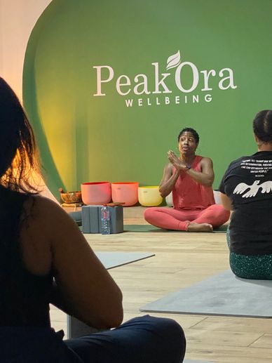 A yoga instructor leads a class at PeakOra Wellbeing.