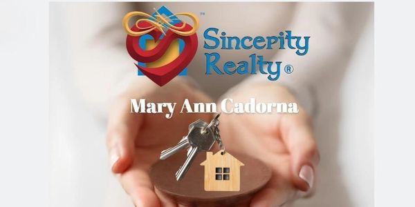 Hands holding house keys with a wooden house keychain, Sincerity Realty logo and agent name.